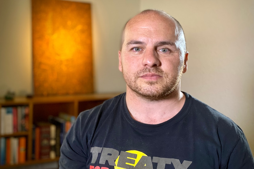 A portrait of Jamie Lowe looking into the camera with a serious expression on his face.