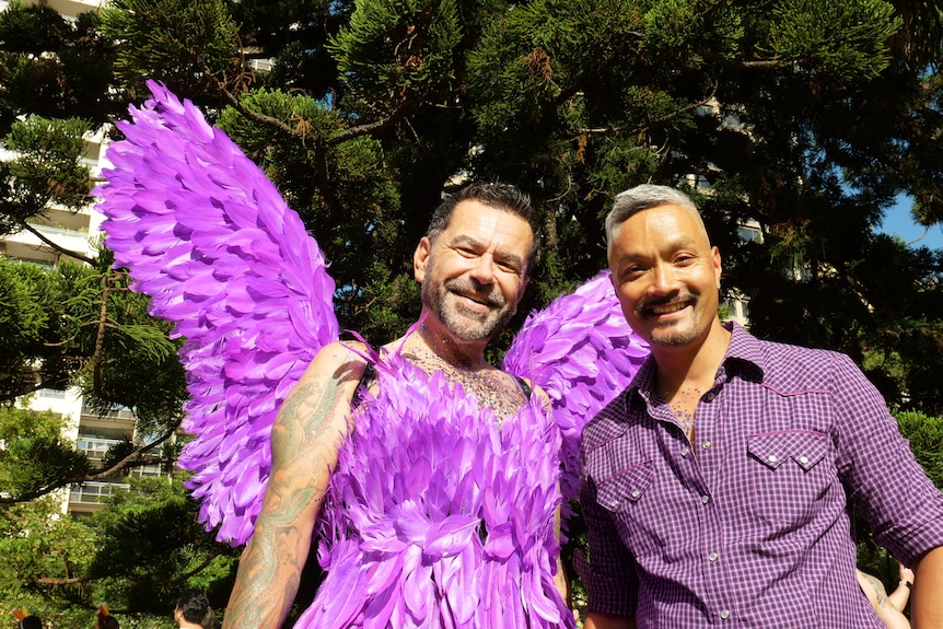 Two men wearing purple outfits.