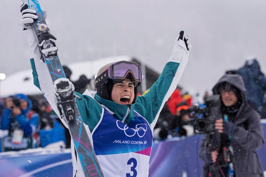 Jakara Anthony celebrates with her arms in the air