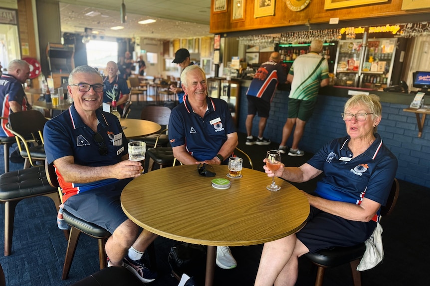 Three seniors are having beer at a pub in a bowling club