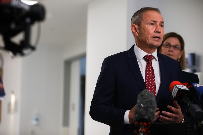 Roger Cook speaks at a press conference.