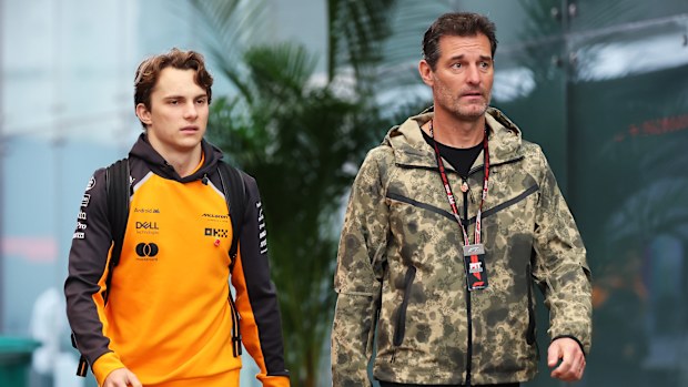 Oscar Piastri of Australia and McLaren and Mark Webber arrive in the Paddock prior to the Sprint ahead of the F1 Grand Prix of Brazil at Autodromo Jose Carlos Pace on November 08, 2025 in Sao Paulo, Brazil. (Photo by Hector Vivas/Getty Images)