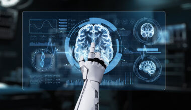 Close up of robotic hand pointing and clicking at brain holographic to access medical data or diagnosis symptom.
