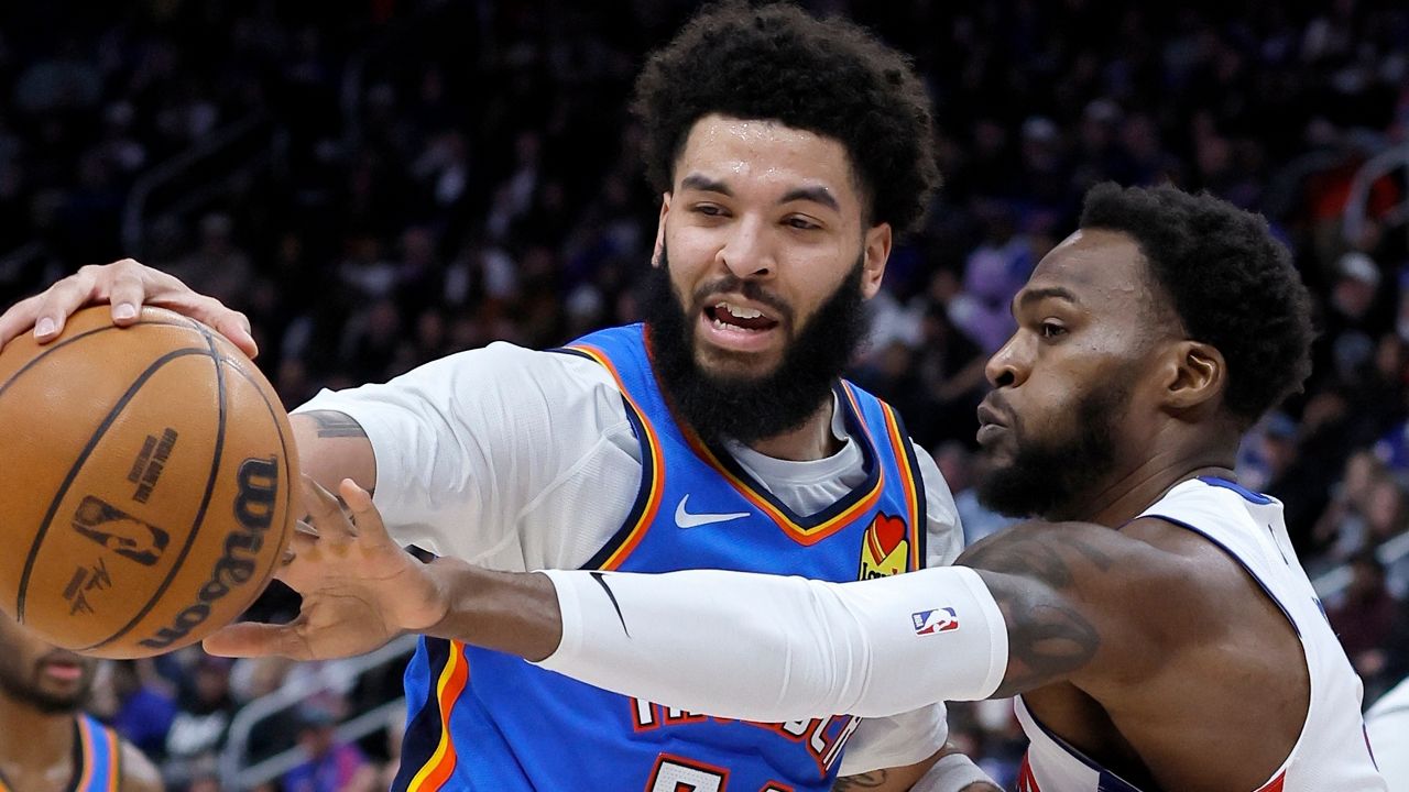 Oklahoma City Thunder guard Kenrich Williams (34) has the ball knocked away by Detroit Pistons forward Paul Reed during the second half of an NBA basketball game, Wednesday, Feb. 25, 2026, in Detroit. (AP Photo/Duane Burleson)