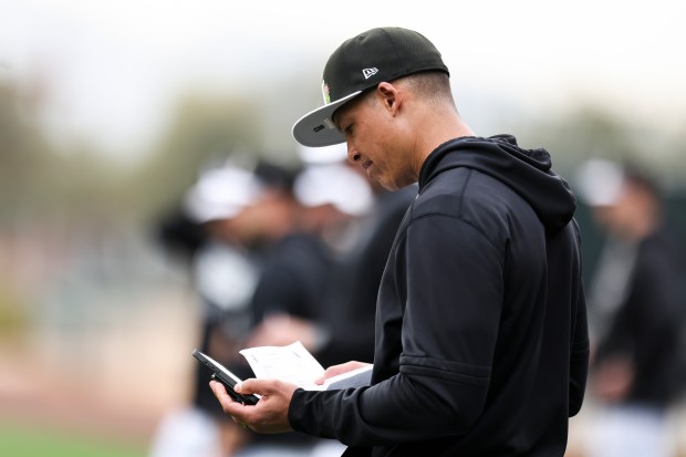 White Sox manager Will Venable looks at a schedule as players practice during spring training at Camelback Ranch on Monday, Feb. 16, 2026, in Glendale, Ariz. (Eileen T. Meslar/Chicago Tribune)