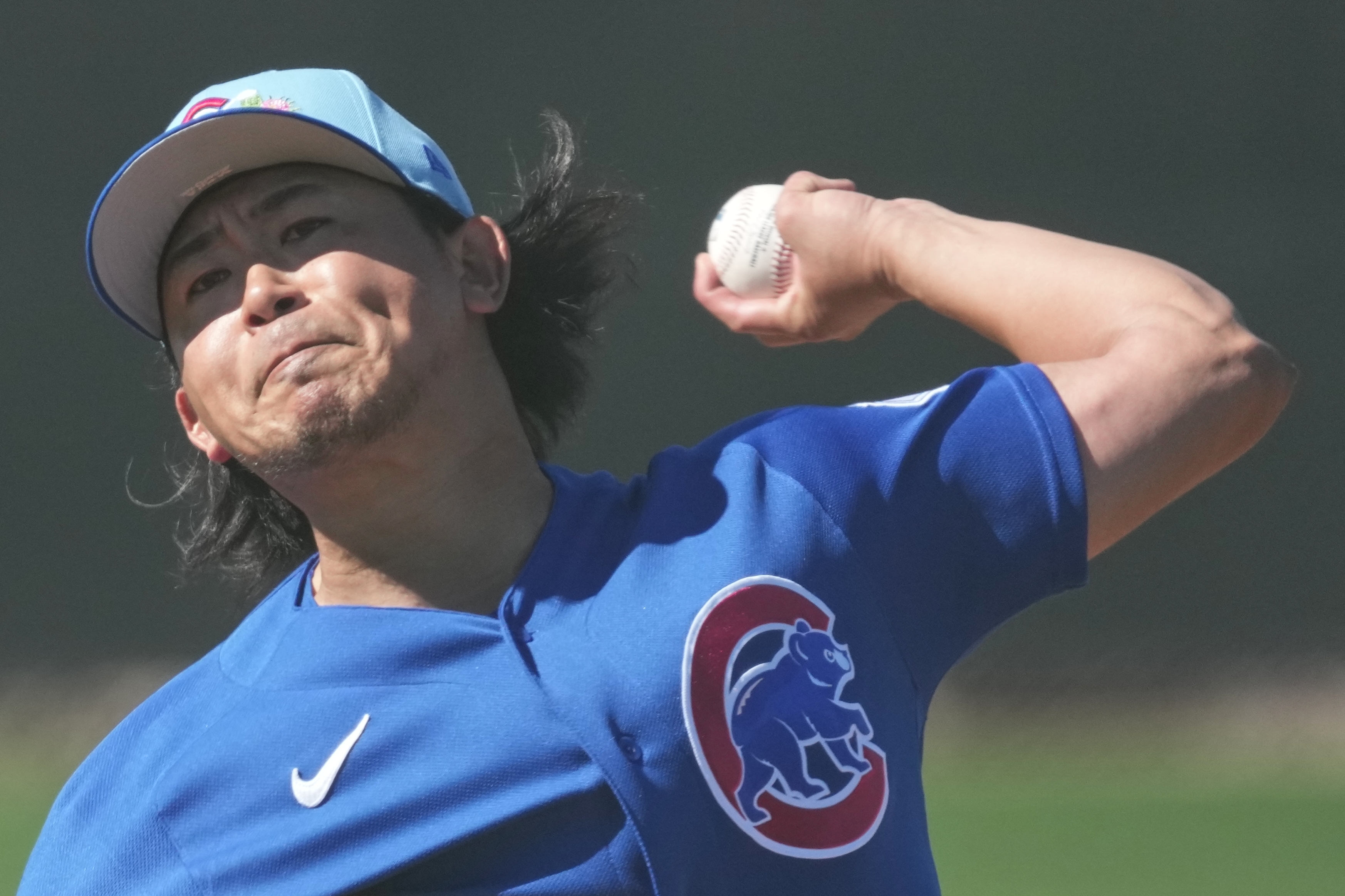 Cubs pitcher Shota Imanaga throws during a spring training workout...