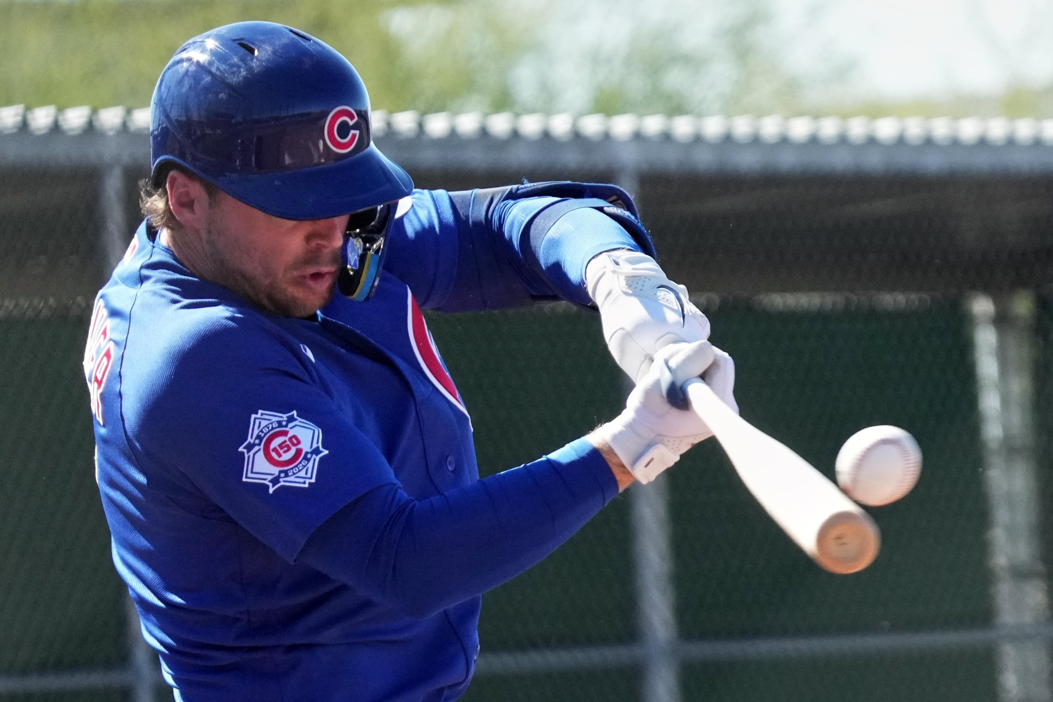 Cubs second baseman Nico Hoerner hits during a spring training...