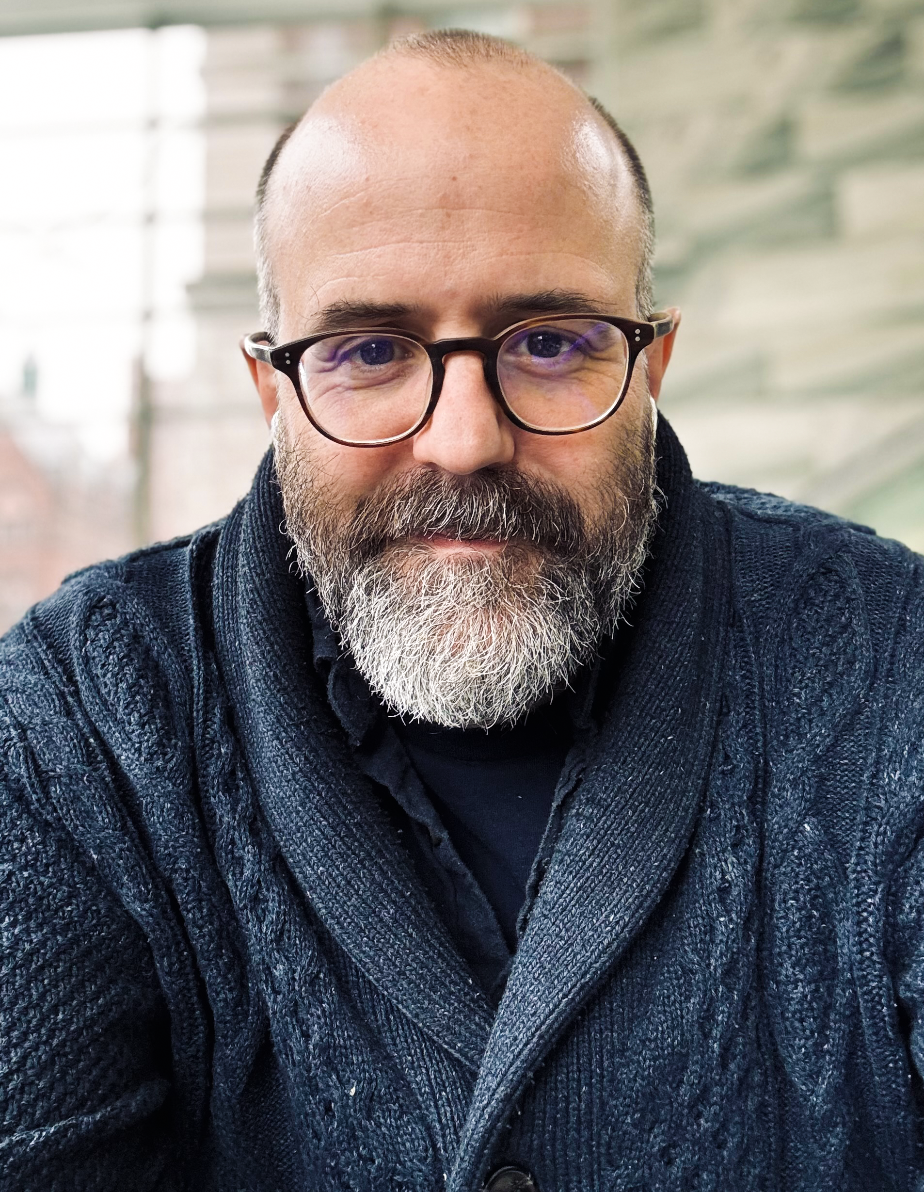 Close-up portrait of a man with glasses and a beard