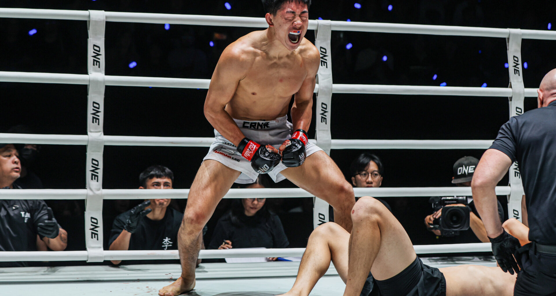 MMA fighter Adrian Lee screams in the ring following his win
