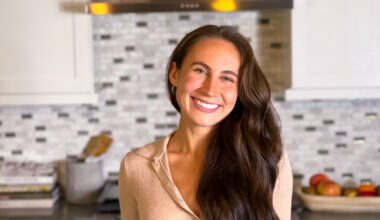 Emmy Clinton smiling in her home kitchen
