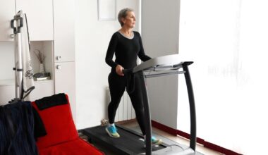 Woman walking on treadmill at home
