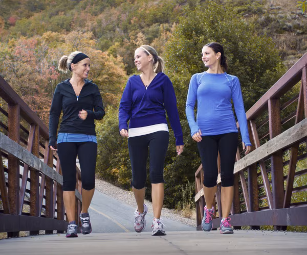 three women walking for fitness outside