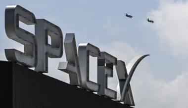 US billionaire businessman and pilot Jared Isaacman flies in formation aboard a fighter jet over the SpaceX sign, close to the Starship spacecraft, before his third test flight from Starbase in Boca Chica, Texas, on March 13, 2024.