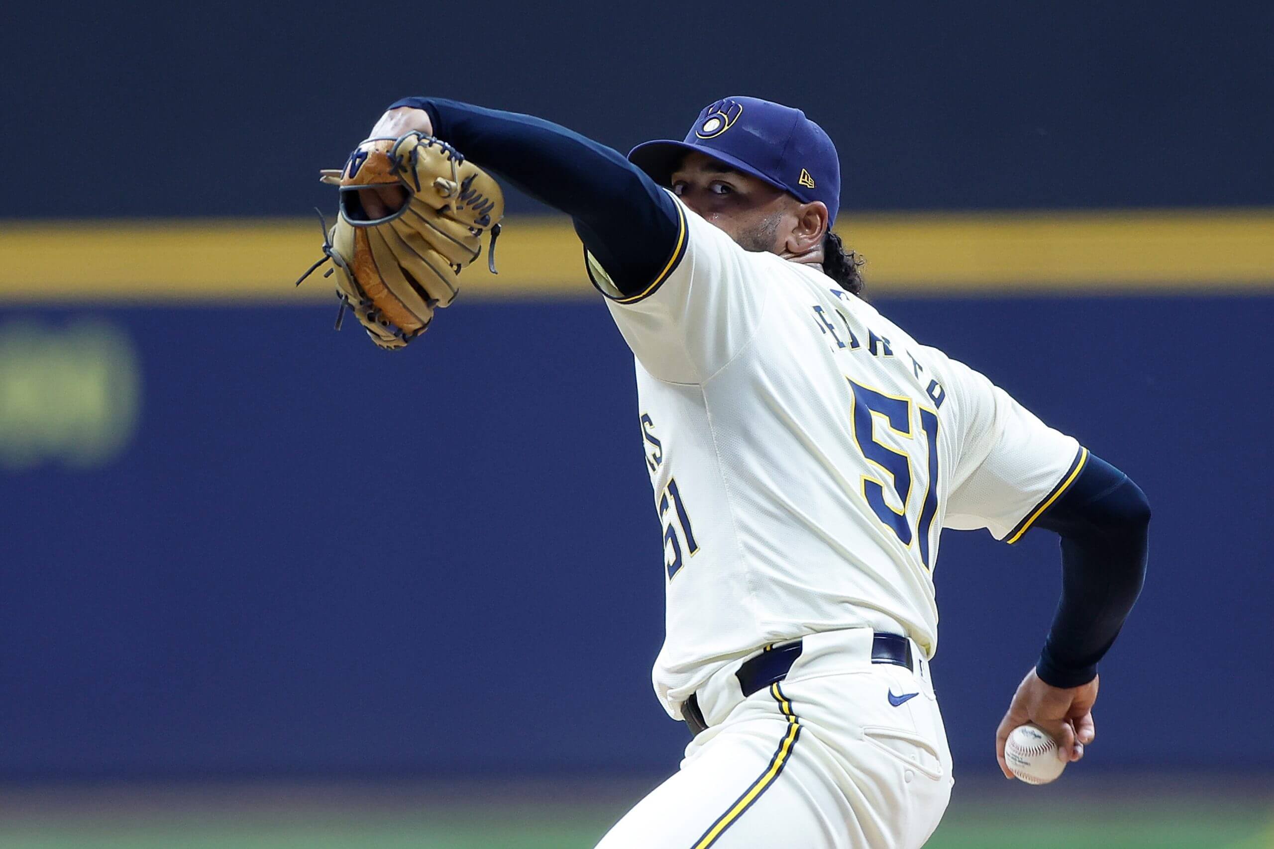 Freddy Peralta rears back to pitch with the ball in his right hand and his glove on his left.