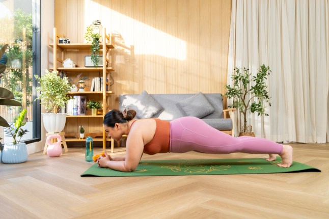 Woman Practicing Yoga Plank Pose in Bright Home Interior