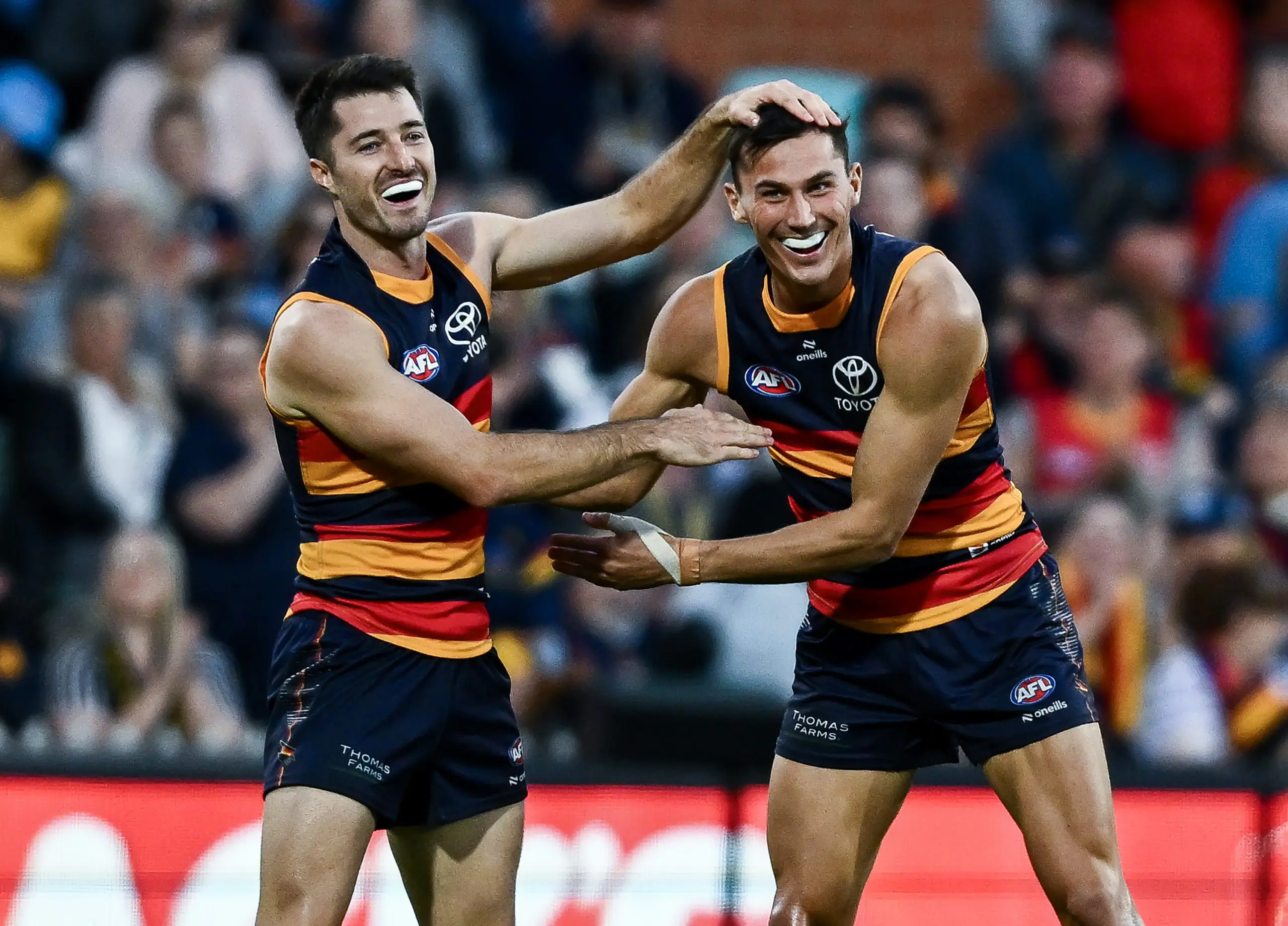 ADELAIDE, AUSTRALIA - MAY 03: Alex Neal-Bullen of the Crows celebrates a goal with Isaac Cumming of the Crows during the round eight AFL match between Adelaide Crows and Carlton Blues at Adelaide Oval, on May 03, 2025, in Adelaide, Australia. (Photo by Mark Brake/Getty Images)