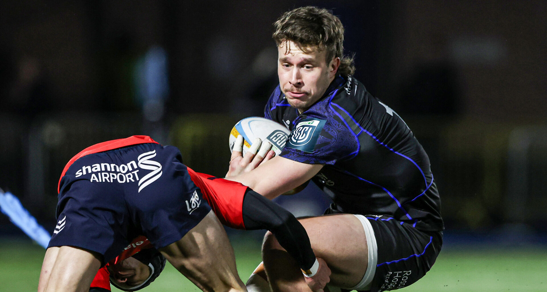 Glasgow Warriors' Kyle Rowe evades a tackle during the January URC match against Munster.