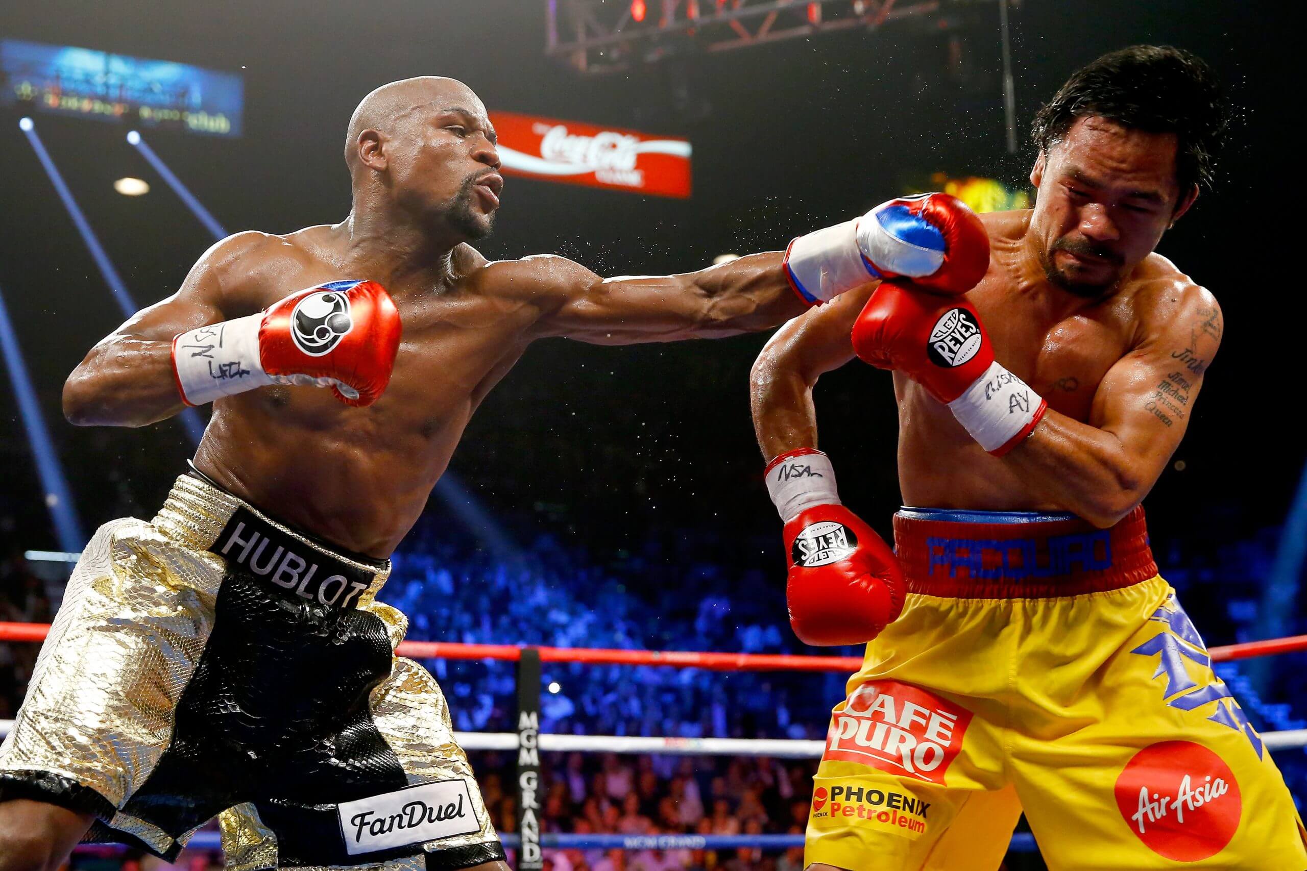 Floyd Mayweather Jr. punches Manny Pacquiao with his left arm extended during their championship fight in 2015.