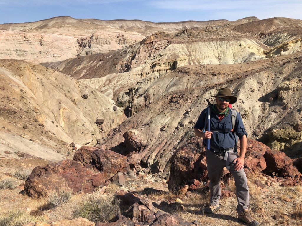Slippery Rock University paleontologist and assistant professor Fabian Hardy standing in the cliffs of Red Rock Canyon State Park. Image credit: Mairin Balisi