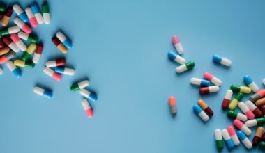 Top view colorful antibiotic capsule pills on blue background.