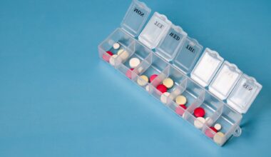 Daily pill box with various pills and tablets for managing medication schedule. medical background with space for text