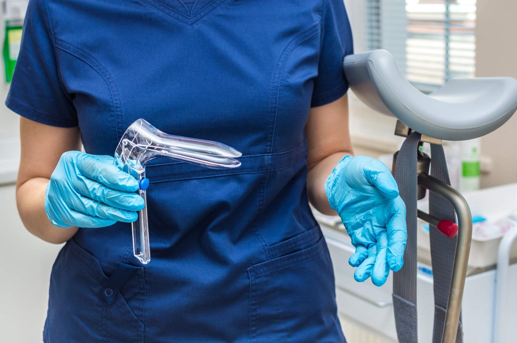Gynecologist holding a gynecological speculum with gloves