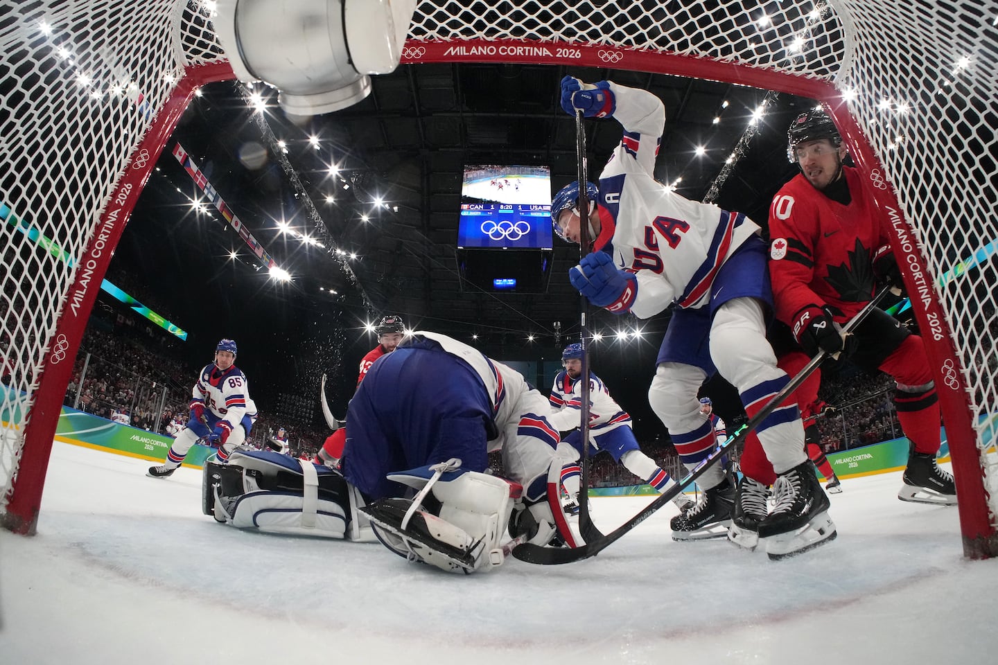 Goalie Connor Hellebuyck got some help from Charlie McAvoy, who kept Canada's Nick Suzuki at bay in the third period. 