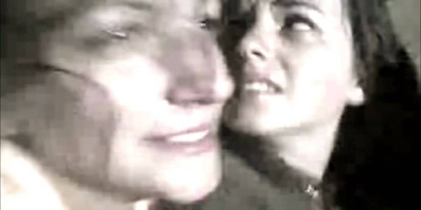 Alice looking back scared in a car with someone next to her in Lake Mungo