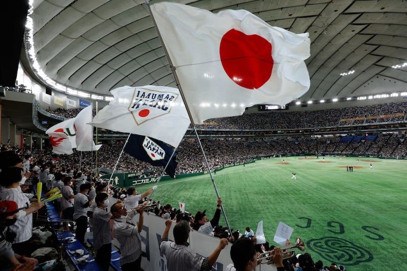 BUNKYO CITY, JAPAN - MARCH 11:   Fans of Team Japan wave flags during Game 6 of Pool B between Team Czech Republic and Team Japan at Tokyo Dome on Saturday, March 11, 2023 in Bunkyo City, Japan. (Photo by Yuki Taguchi/WBCI/MLB Photos via Getty Images)