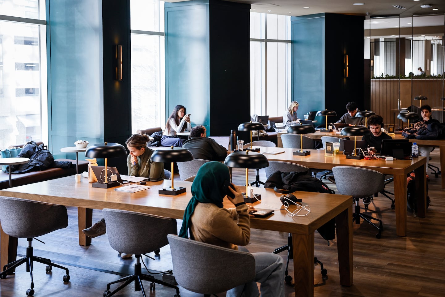 Gym members worked on laptops in a shared lounge and workspace at the recently opened Life Time fitness club, on Jan. 23.