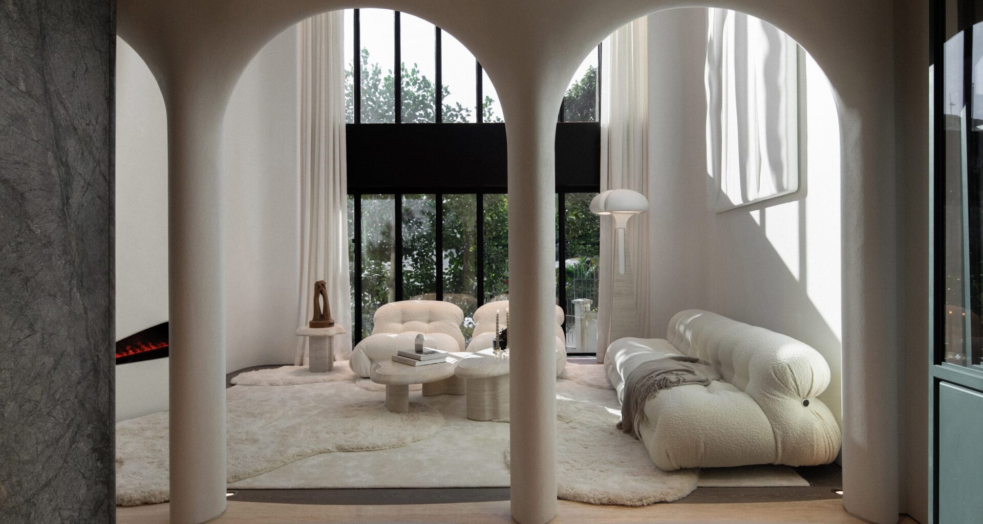 An image showing a contemporary, white living room that can be seen through curved archways.