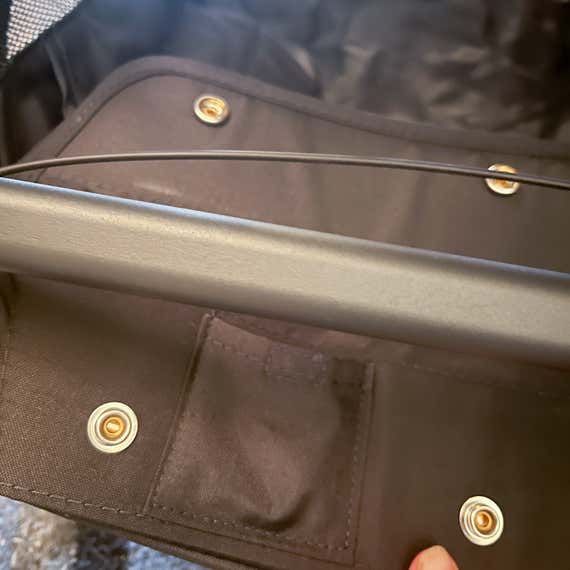 The AirTag pocket, hidden in the inside of the handle cover on the Uppababy Minu V3 travel stroller.