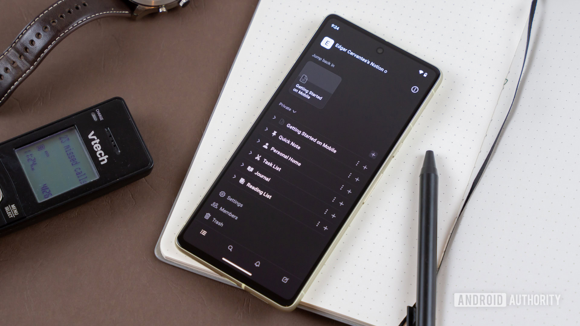 Notion app on smartphone next to other office products Notion app on smartphone next to other office products