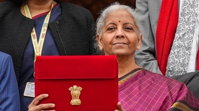 Finance Minister Nirmala Sitharaman shows the digital tablet, enclosed in a traditional red 'bahi-khata' style pouch, at the Parliament. (PTI)