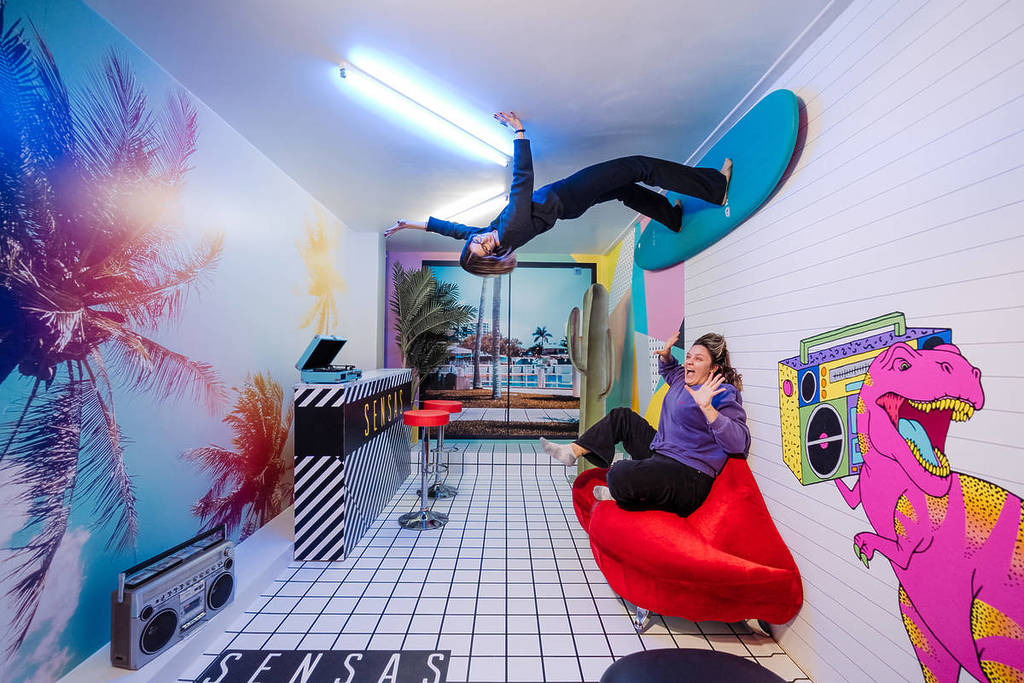 Two women pose for a photo in the Anti-Gravity room at SENSAS.