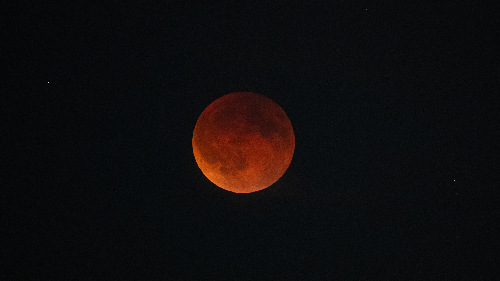 A red full moon is pictured in a black sky during a total lunar eclipse.