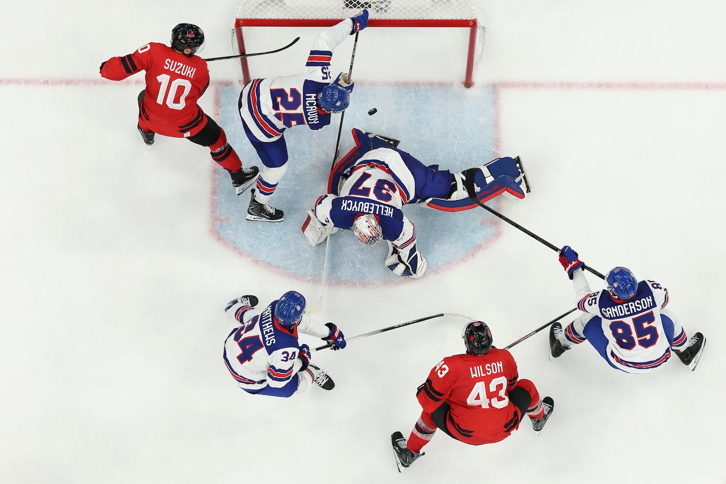 Defenseman Charlie McAvoy (25) and goalie Connor Hellebuyck combined to deny Canada during the third period the the gold-medal game Sunday.
