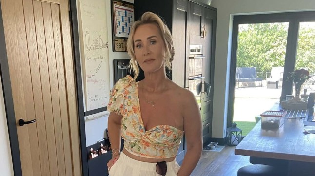 Michelle Sword with her hands in her pockets, smiling at the camera