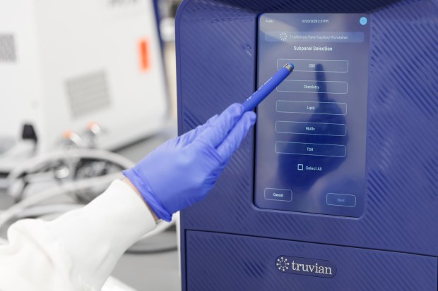 Truvian co-founder and Chief Operating Officer Dena Marrinucci demonstrates how one of their blood testing machines TruVerus is used at Truvian on Tuesday, Jan. 20, 2026 in San Diego, California. (Meg McLaughlin / The San Diego Union-Tribune)