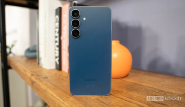 Samsung Galaxy S25 FE in Navy standing on book shelf