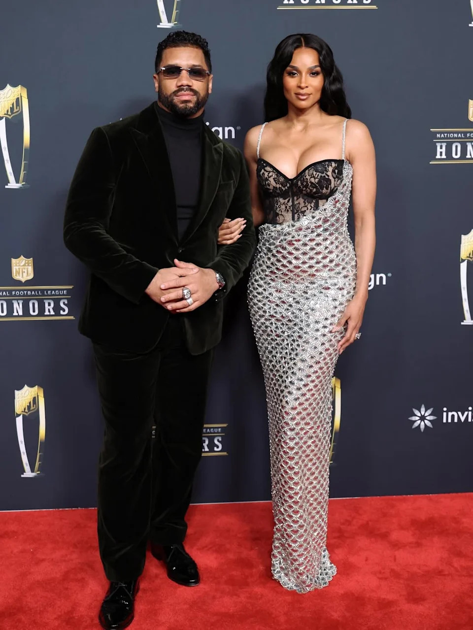 Ciara wore a custom Valdrin Sahiti gown featuring a lace corset bodice and a shimmering silver skirt.