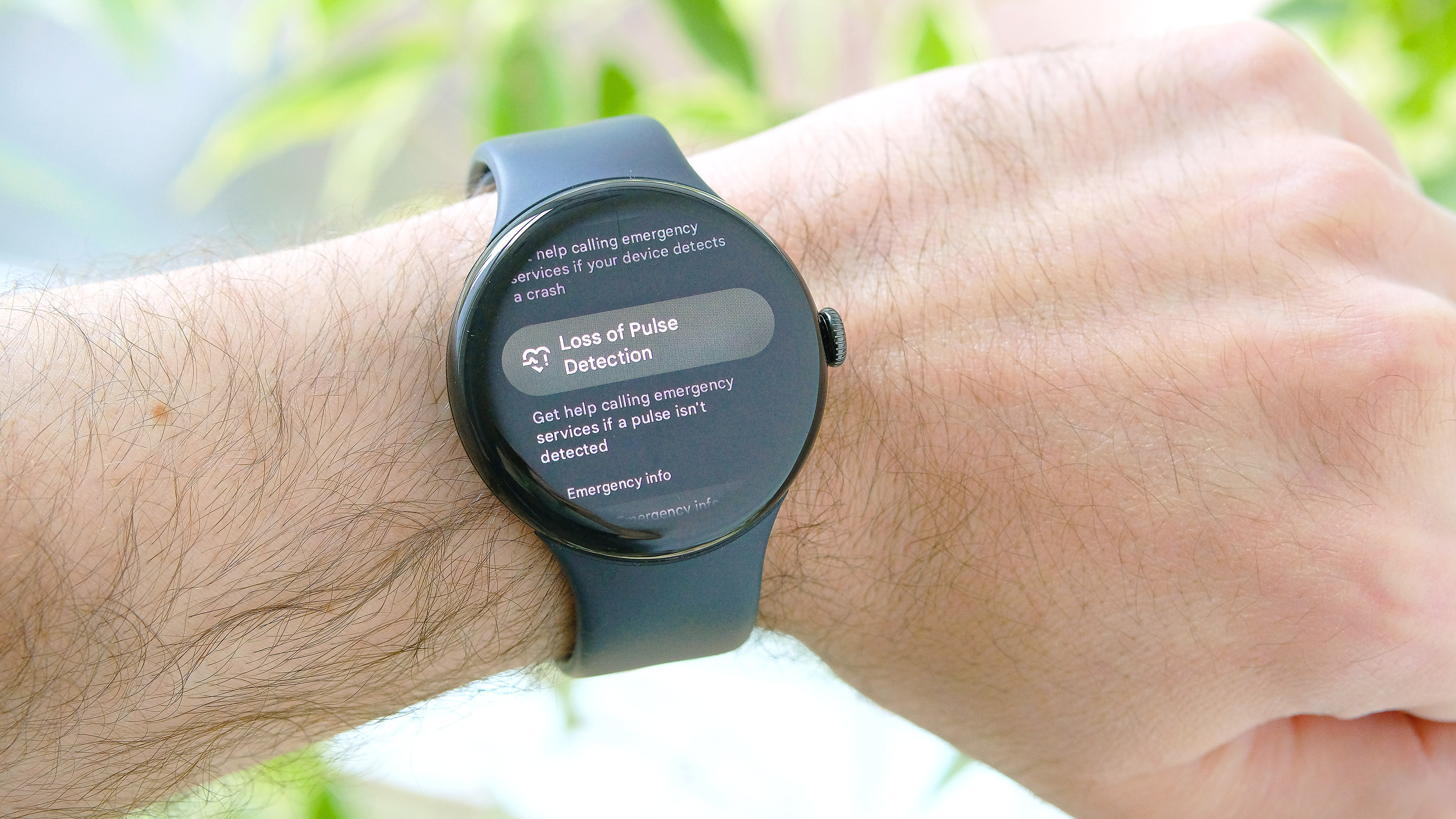 A close-up of the Google Pixel 9 showing the process for enabling Loss of Pulse Detection on the Pixel Watch 3