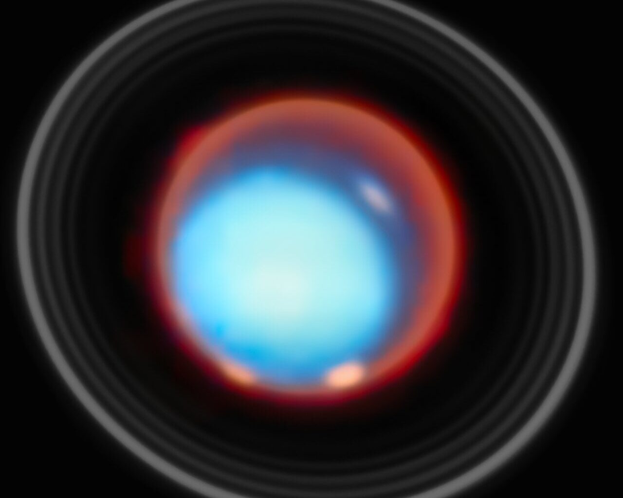 JWST's NIRSpec instrument detected two bright auroral bands near Uranus’s magnetic poles, together with reduced emission and ion density in part of the region between the two bands (a feature likely linked to transitions in magnetic field lines). Credit: ESA/Webb, NASA, CSA, STScI, P. Tiranti, H. Melin, M. Zamani (ESA/Webb)
