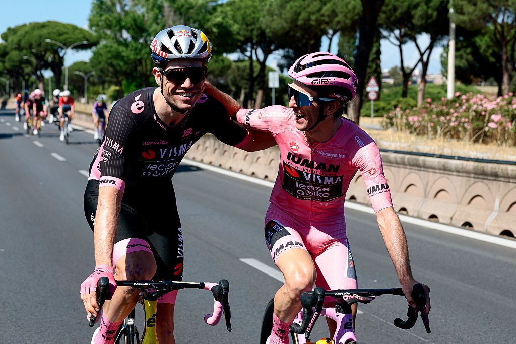 Team Visma-Lease a Bike's Belgian rider Wout Van Aert and Team Visma-Lease a Bike's British rider Simon Yates wearing the pink jersey of overall leader (Maglia Rosa) react as they ride during the 21st and last stage of the 108th Giro d'Italia cycling race of 143kms from Rome to Rome on June 1, 2025. (Photo by Luca Bettini / AFP)