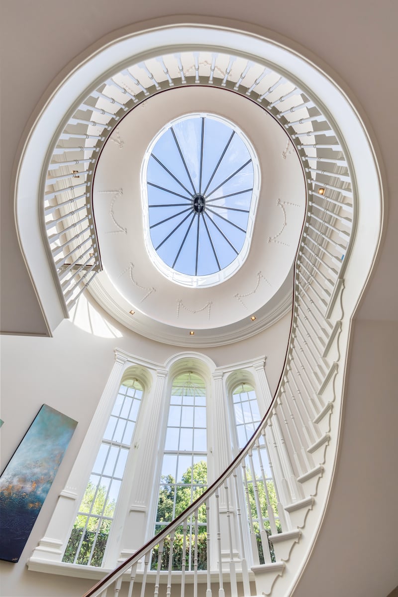 Mahogany staircase in reception hall with oval skylight