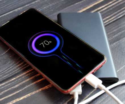 a power bank charging an Android phone