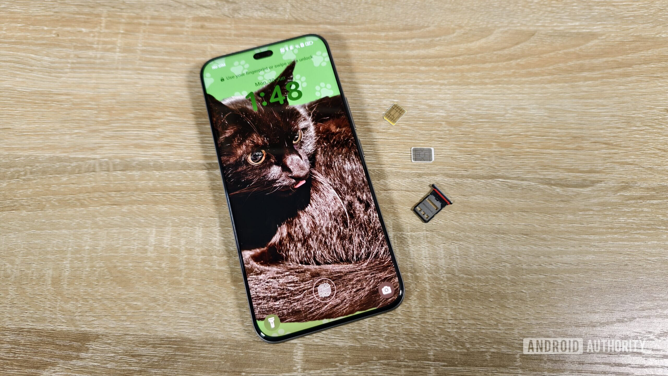 a smartphone with two sim cards and a sim tray on a table a smartphone with two sim cards and a sim tray on a table