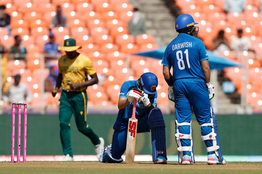 Afghanistan batter Rahmanullah Gurbaz on one knee after getting out.