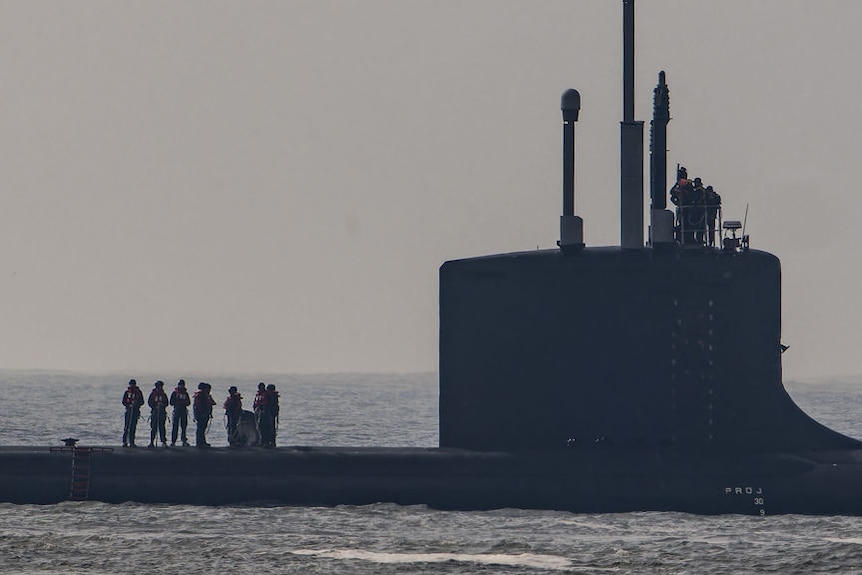A submarine on the waterline.