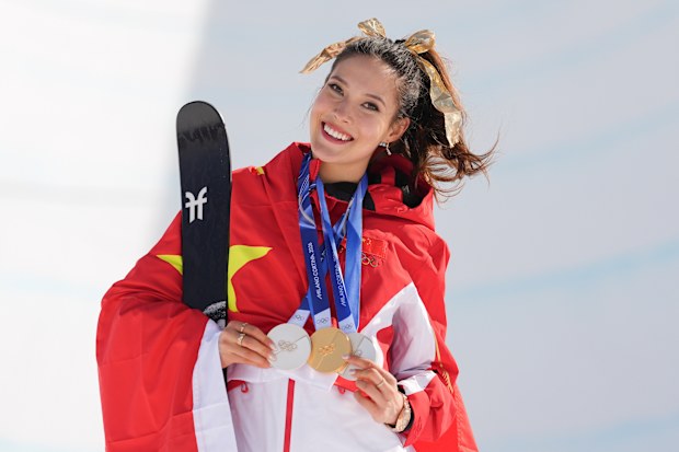 Gold medallist China's Eileen Gu poses with her medals after winning the women's freestyle skiing halfpipe final at the 2026 Winter Olympics, in Livigno, Italy, Sunday, Feb. 22, 2026. (AP Photo/Abbie Parr)
